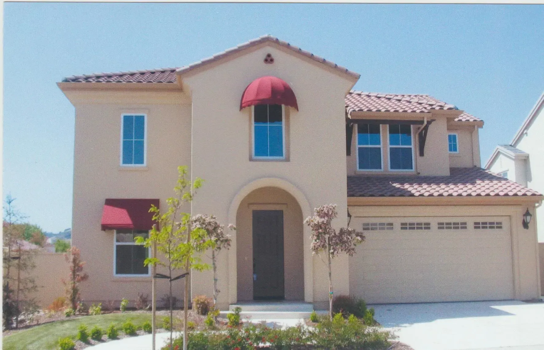 A house with a red awning on the front of it