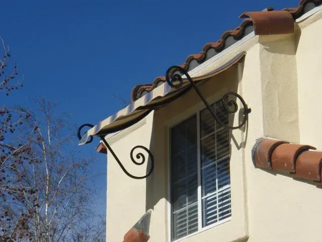 A white building with a window and a gutter