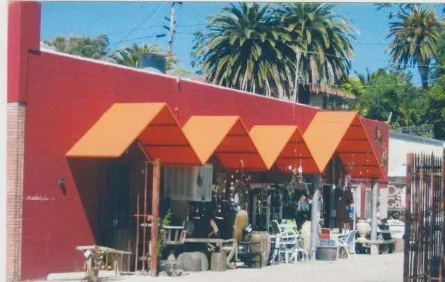 A red building with orange awnings on it