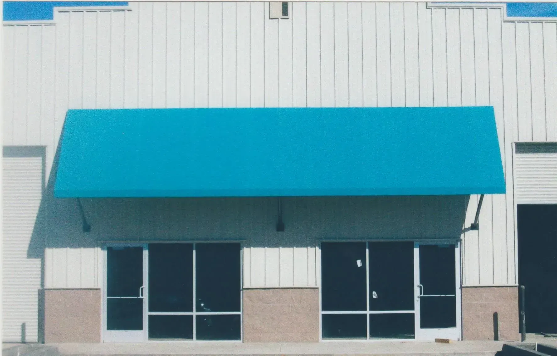 A building with a blue awning on top of it