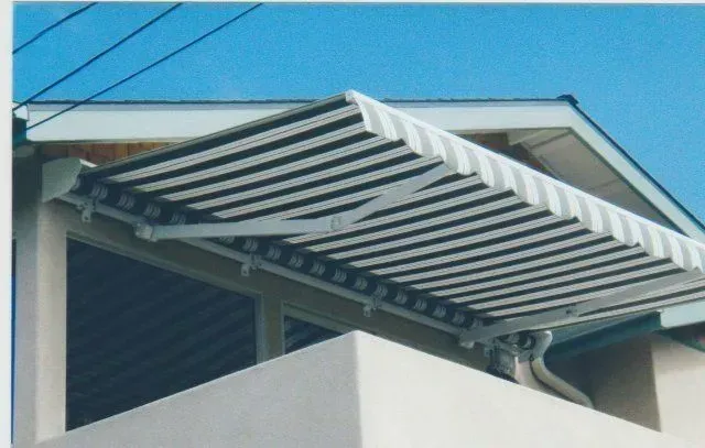 A yellow awning is attached to the side of a building A yellow awning is attached to the side of a building