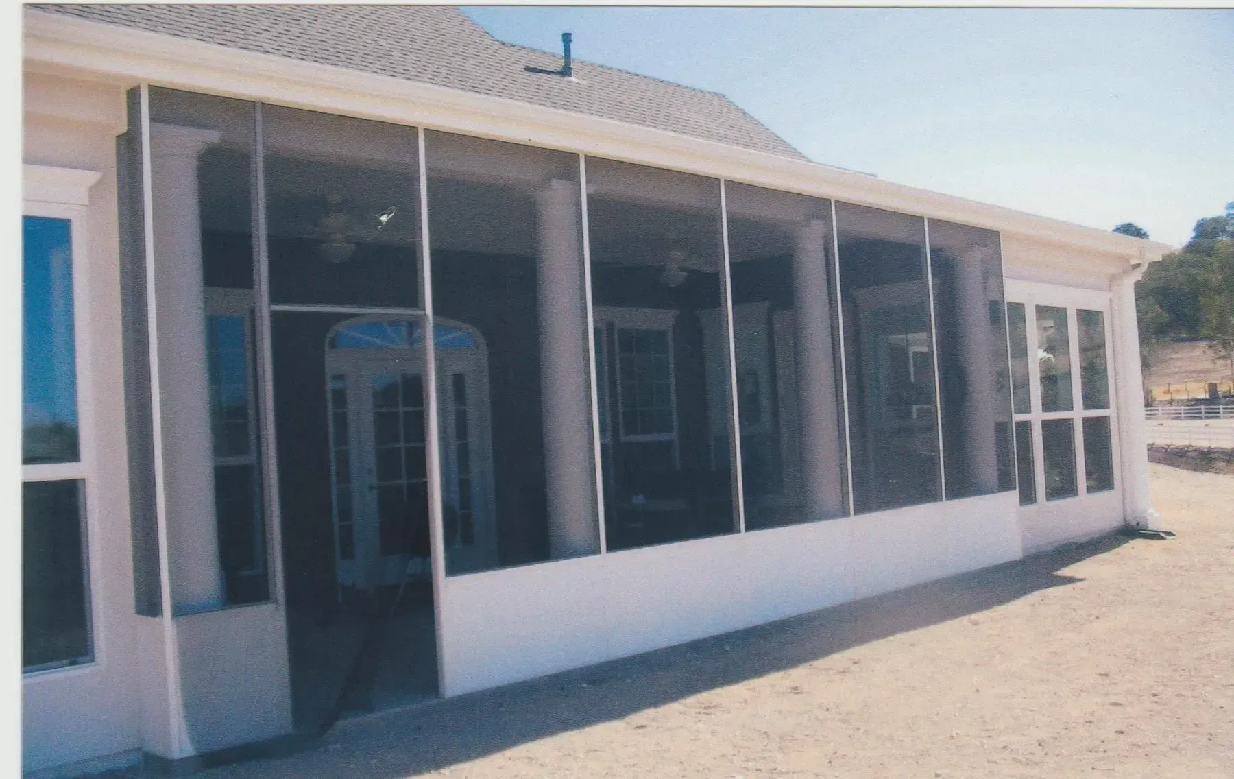 A screened in porch with a lot of windows