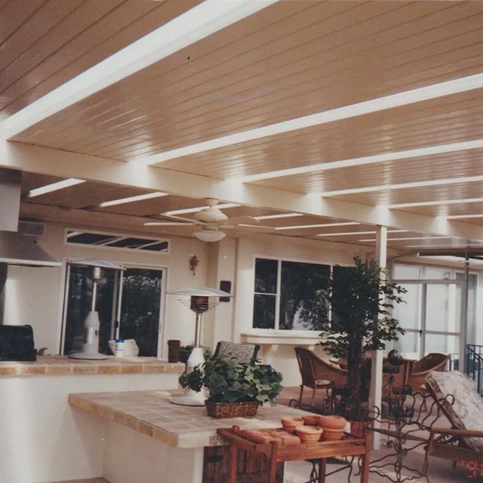 A room with a table and chairs and a ceiling fan A room with a table and chairs and a ceiling fan