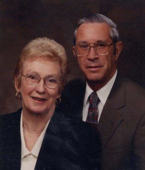 A man and a woman are posing for a picture together