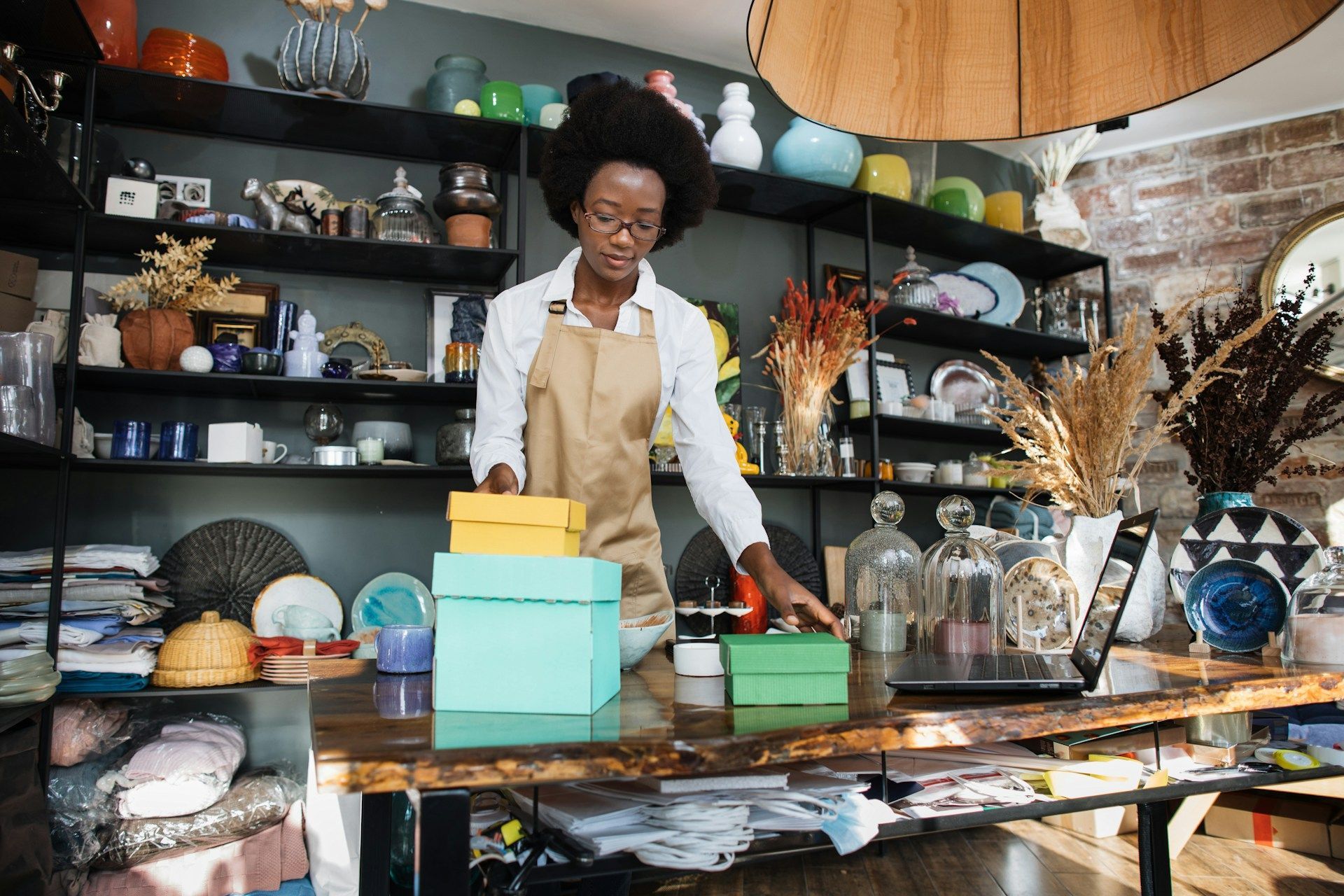 A woman is standing at a counter in a store.