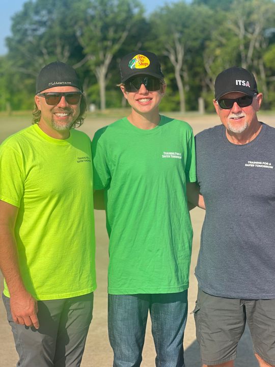 Three men are posing for a picture together