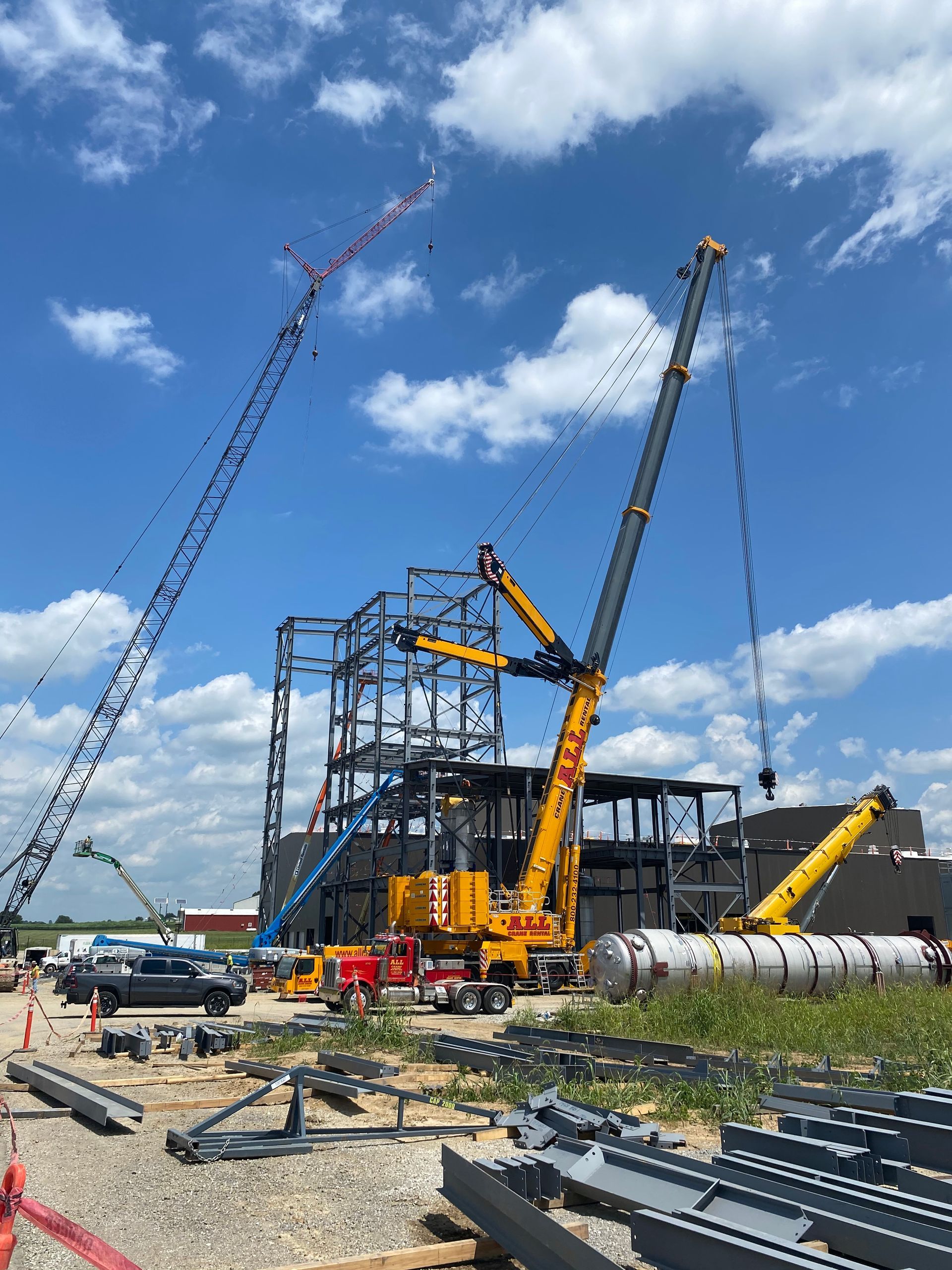 A construction site with a lot of cranes and a building under construction.