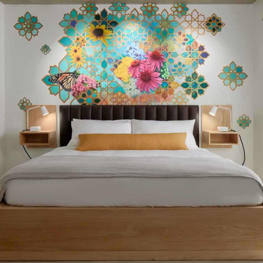 Image of interior of hotel room 7 with floral artwork in the background.