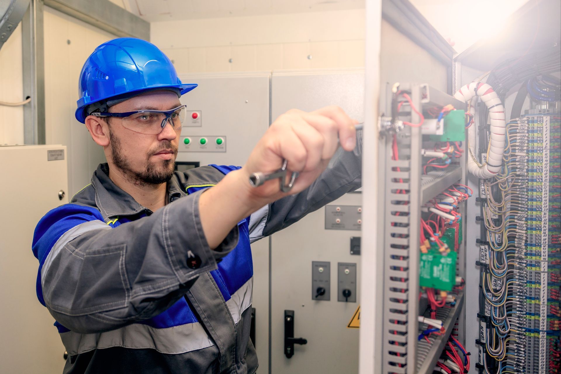 man engaged in electromechanical assembly