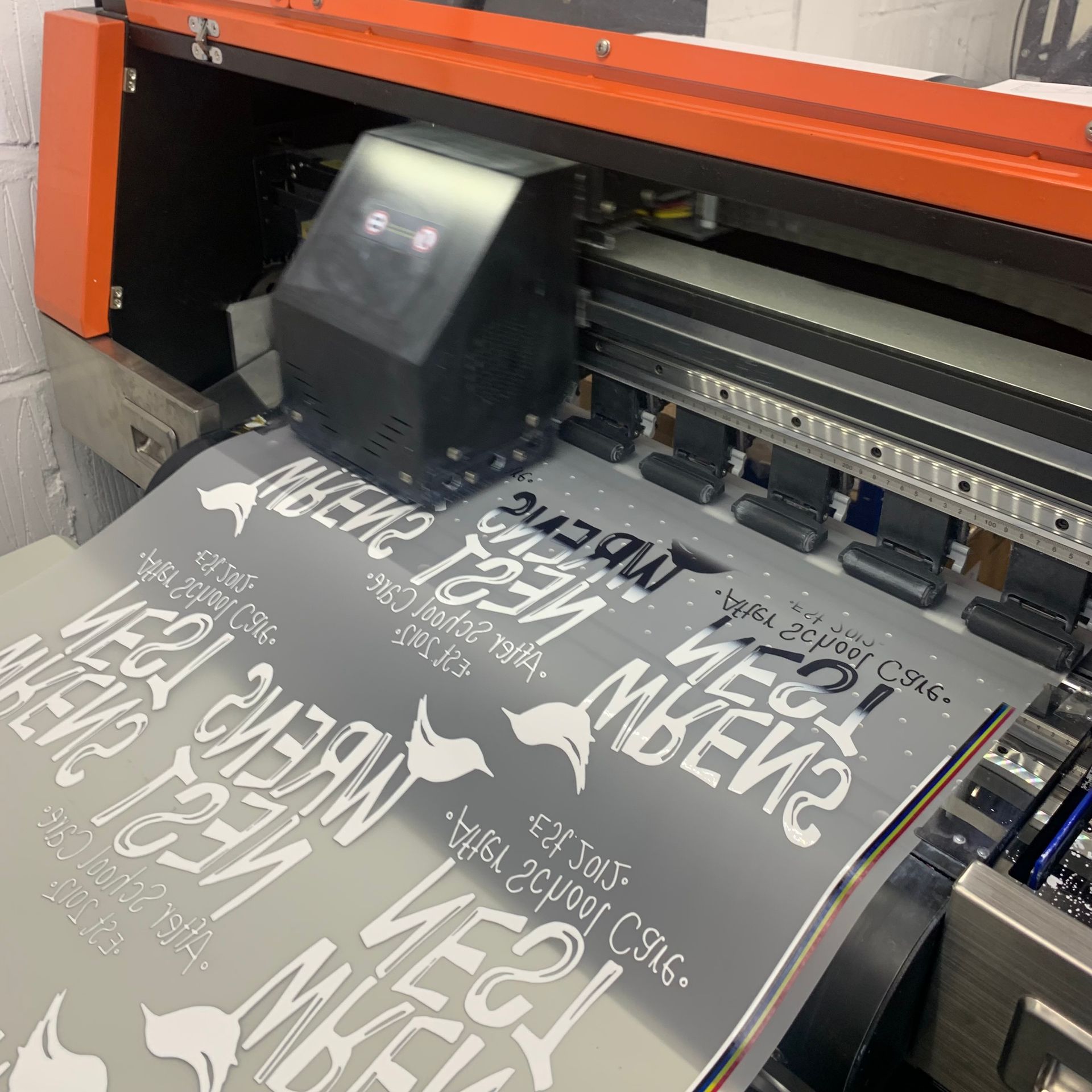 WhiteLodge Large format printer printing reflective material with white text and a bird logo.