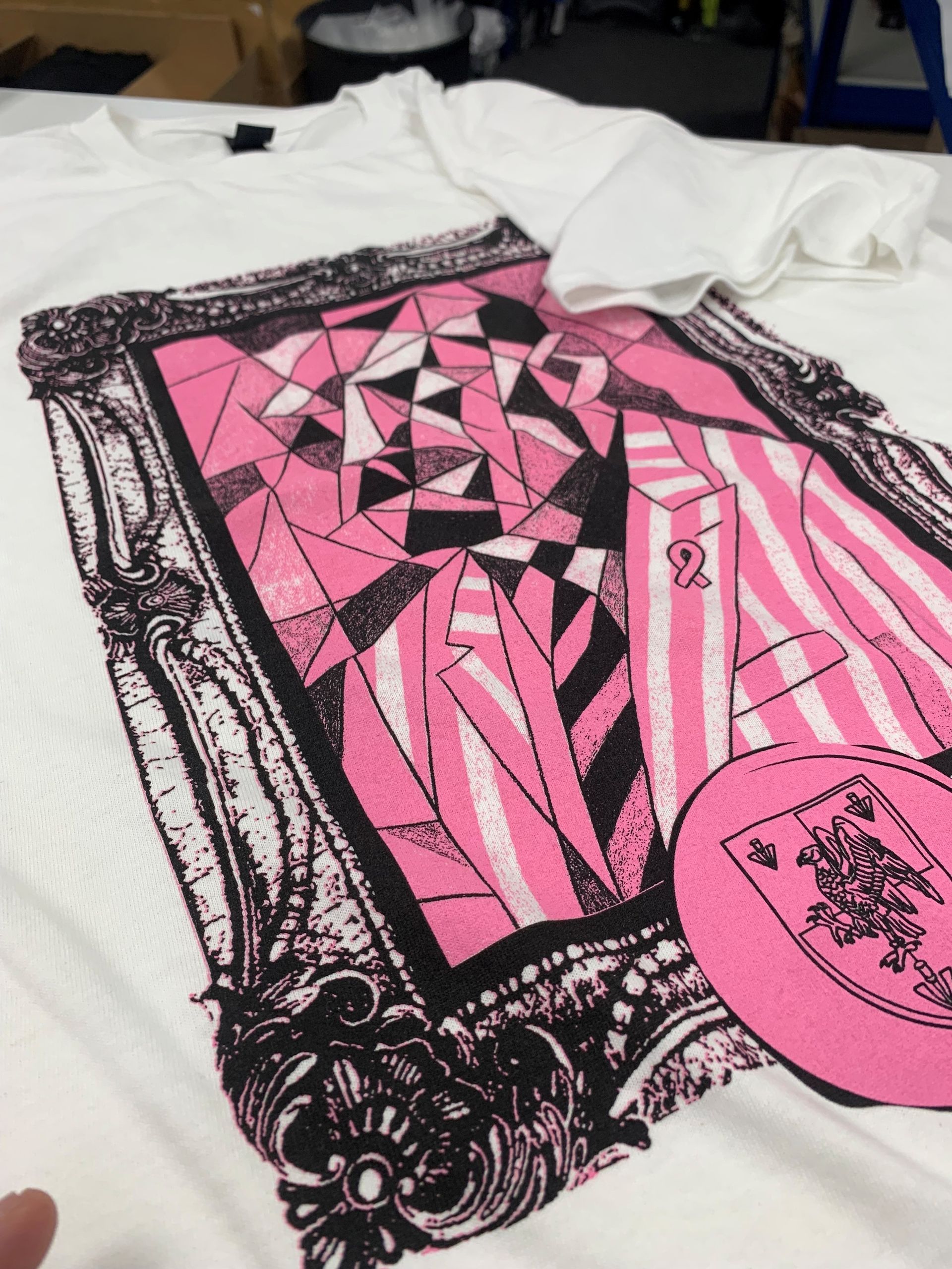 WhiteLodge White t-shirt with a pink and black art print in a frame. Includes a pink circle illustration.