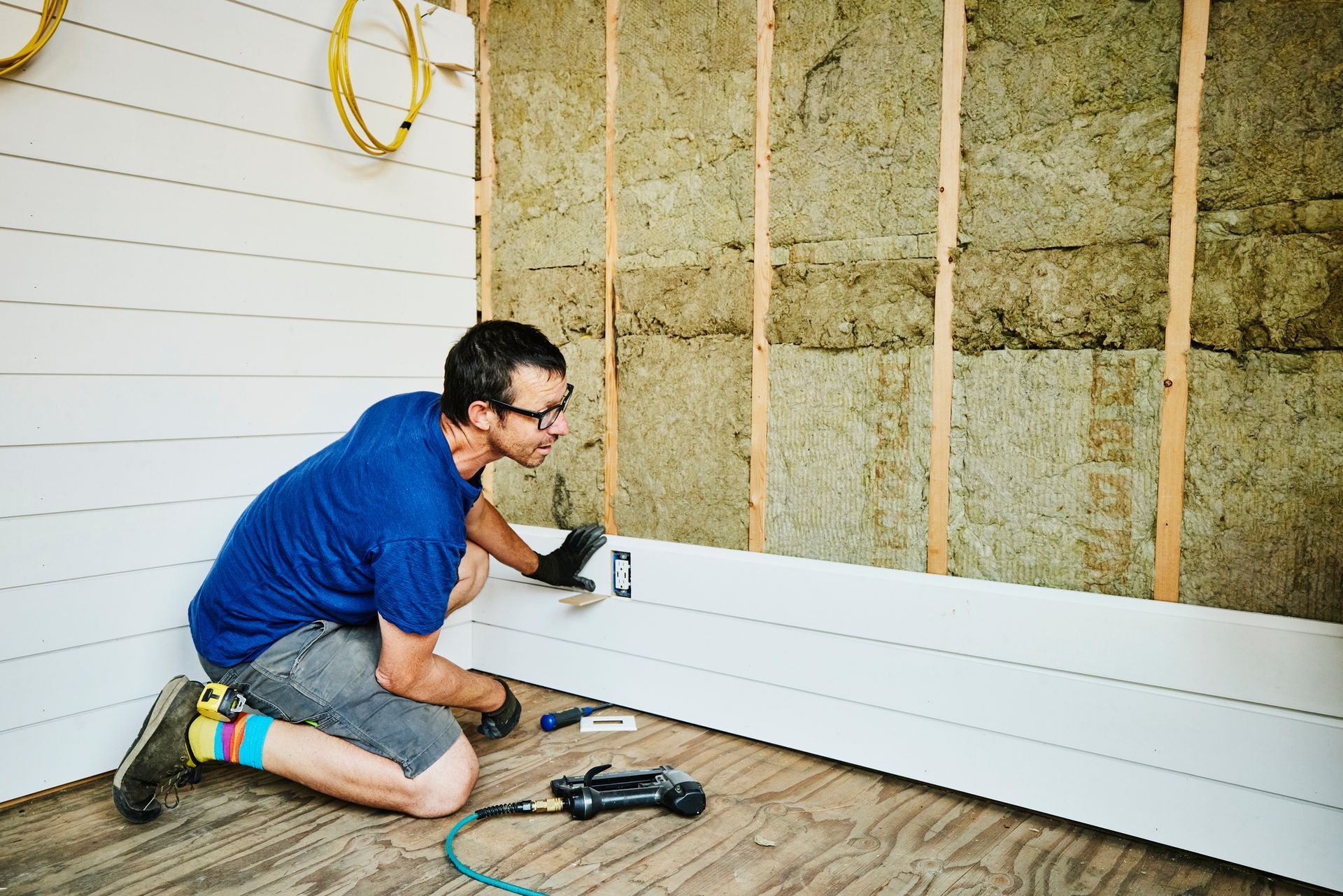 Commercial siding contractor installing siding during a construction project.