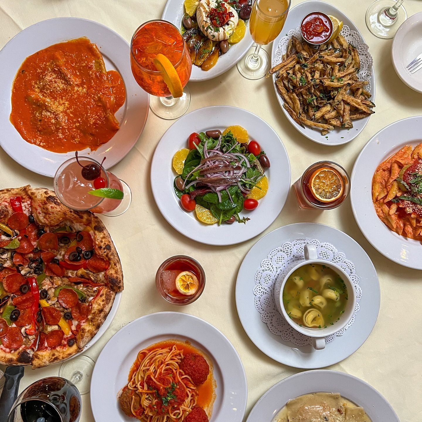 A table topped with plates of food and drinks