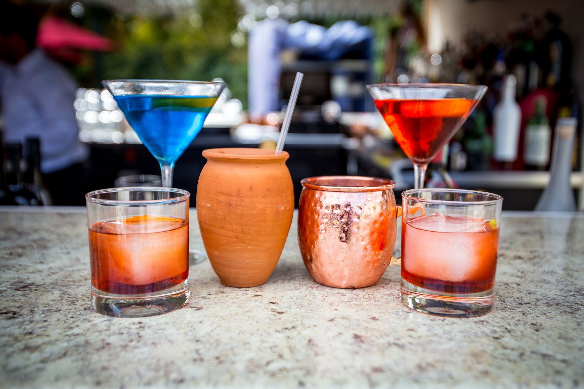 Four different types of drinks are sitting on a counter.