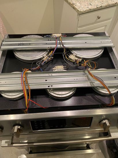 Open electronic device with exposed wiring and cooling fans on a workbench