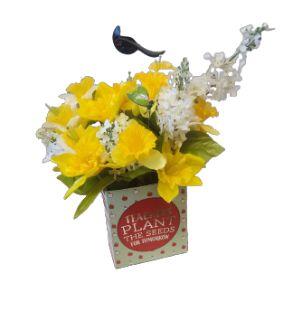 A bouquet of yellow and white flowers in a box that says 