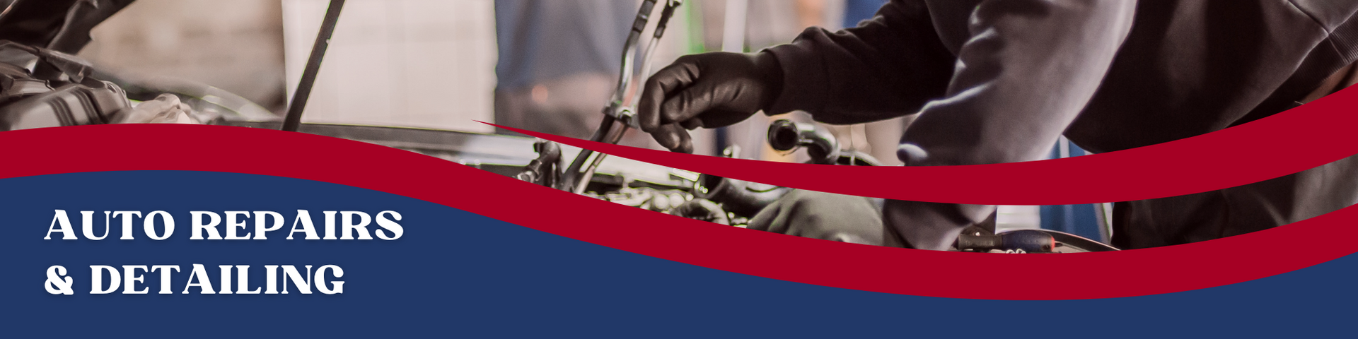 A person works on an engine under the red and blue banner text