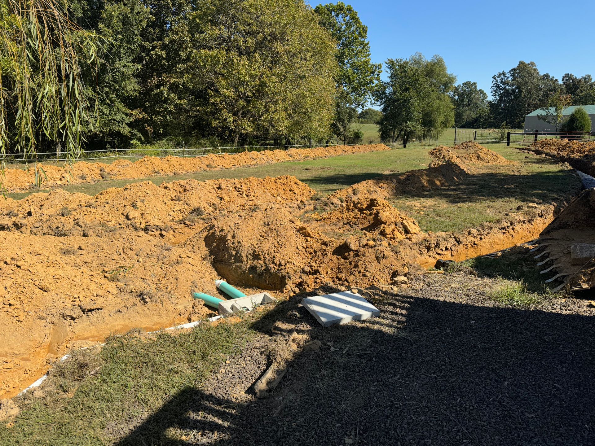 A large pile of dirt is sitting in the middle of a field.