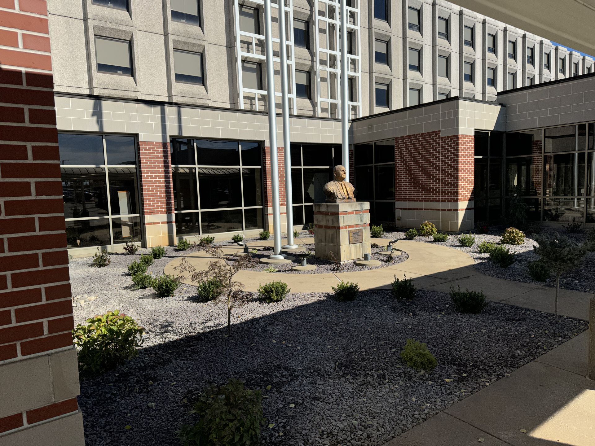 A brick building with a statue in front of it
