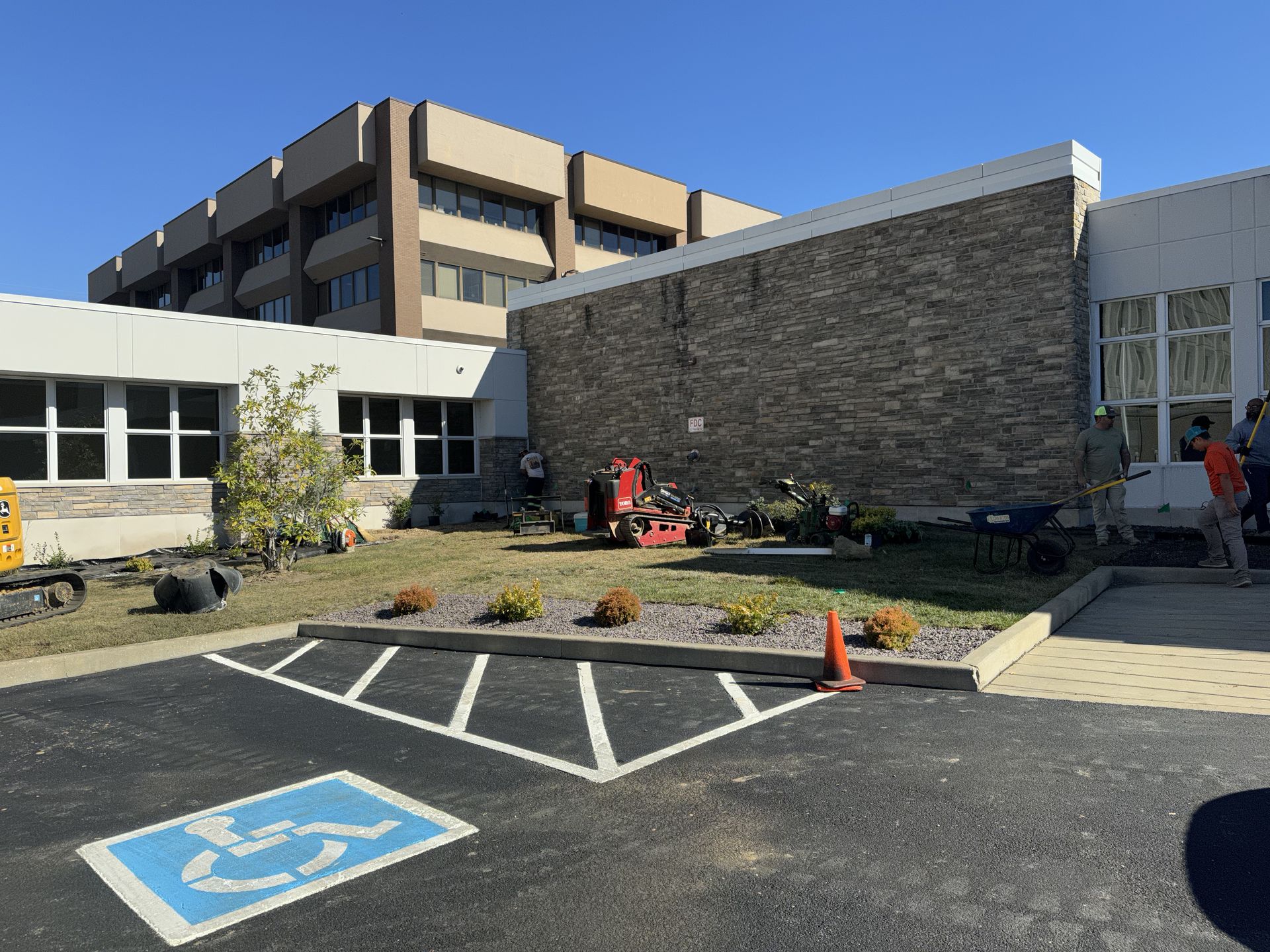 A handicapped parking spot is in front of a large building.