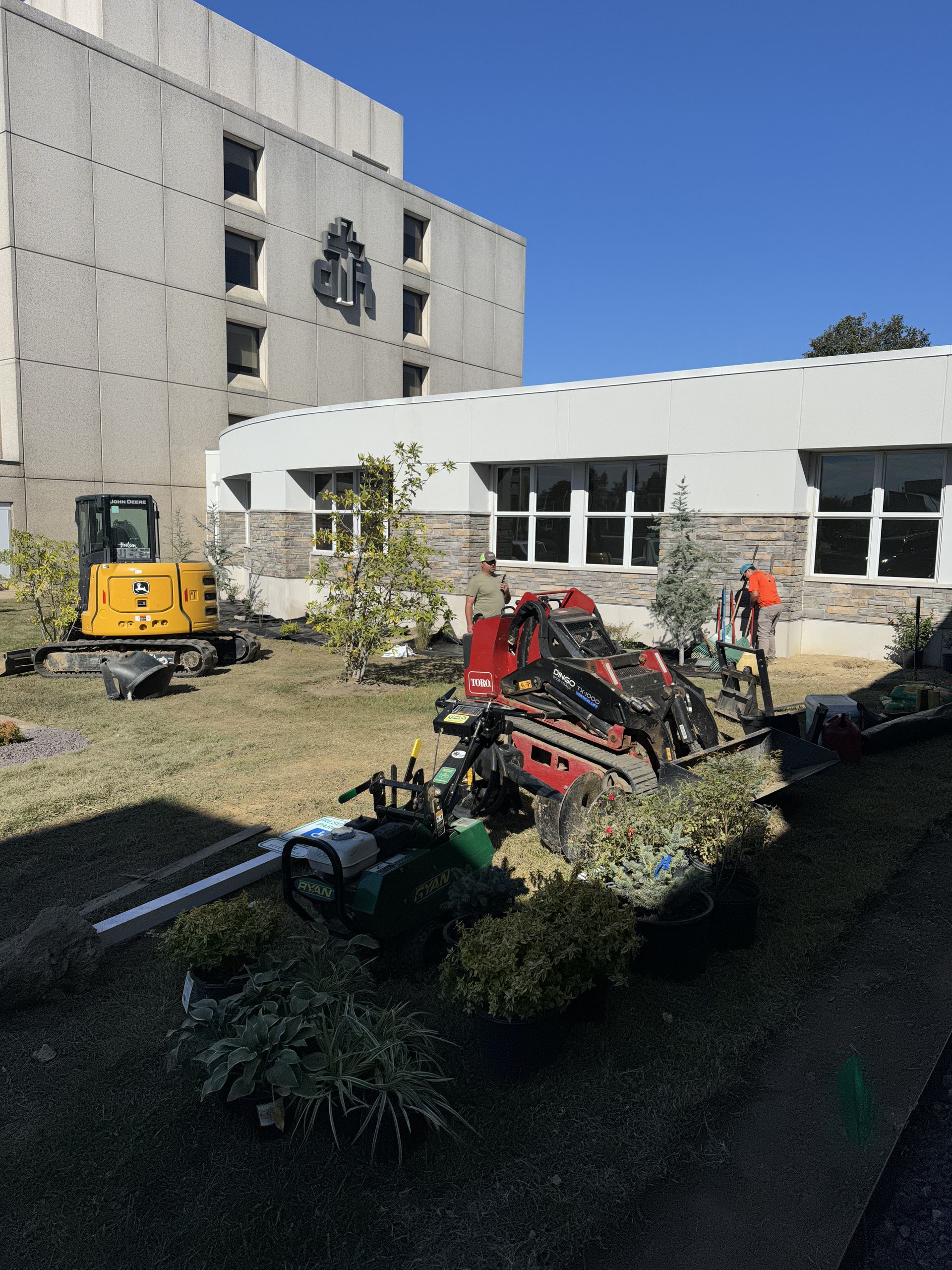 A construction site with a large building in the background