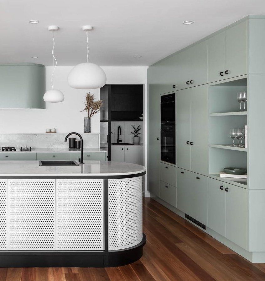 A Kitchen With Green Cabinets and a Large Island in the Middle — Paiano Custom Kitchens In Corrimal, NSW