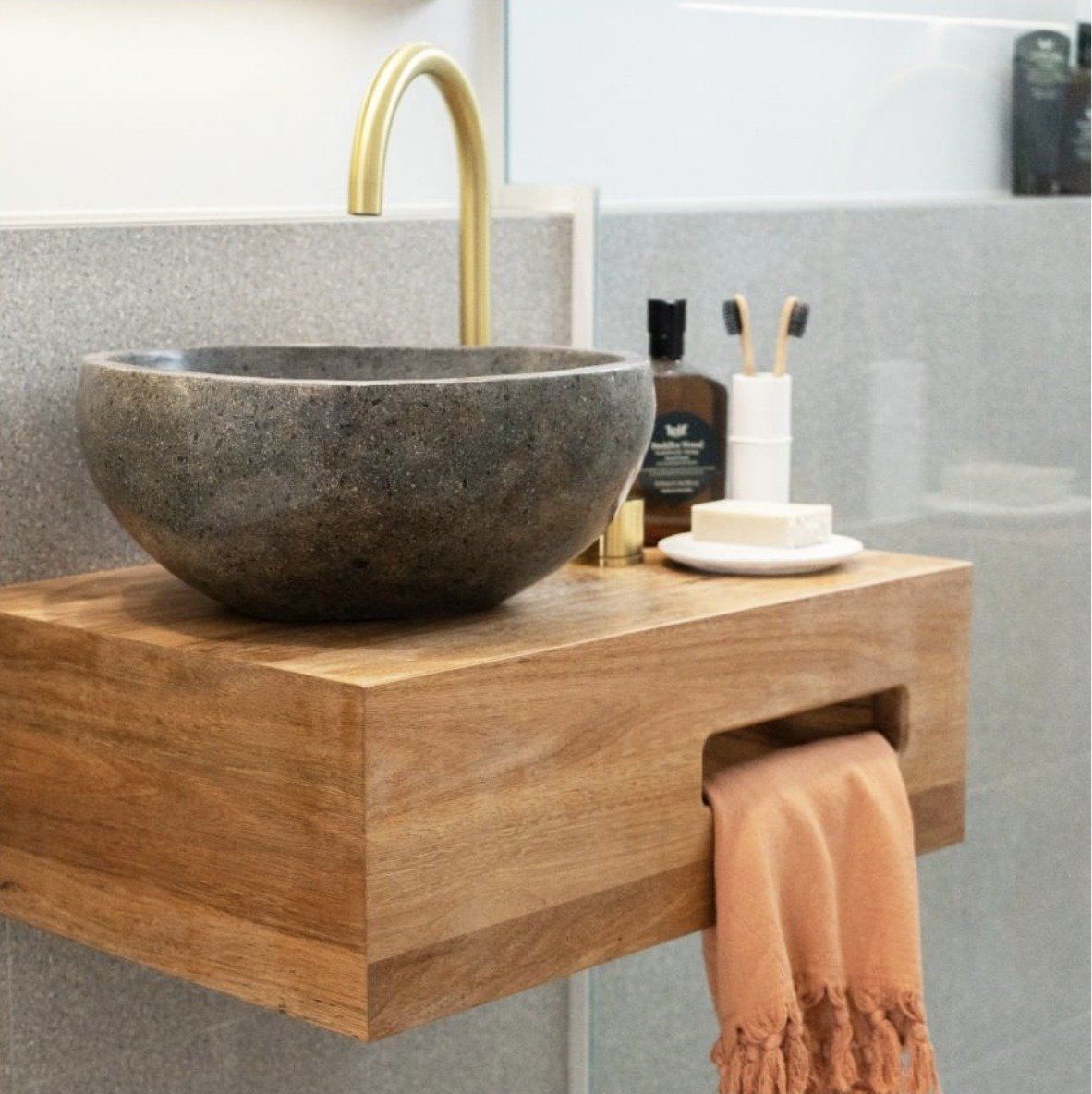 A Bathroom With a Stone Sink on a Wooden Shelf — Paiano Custom Kitchens In Corrimal, NSW