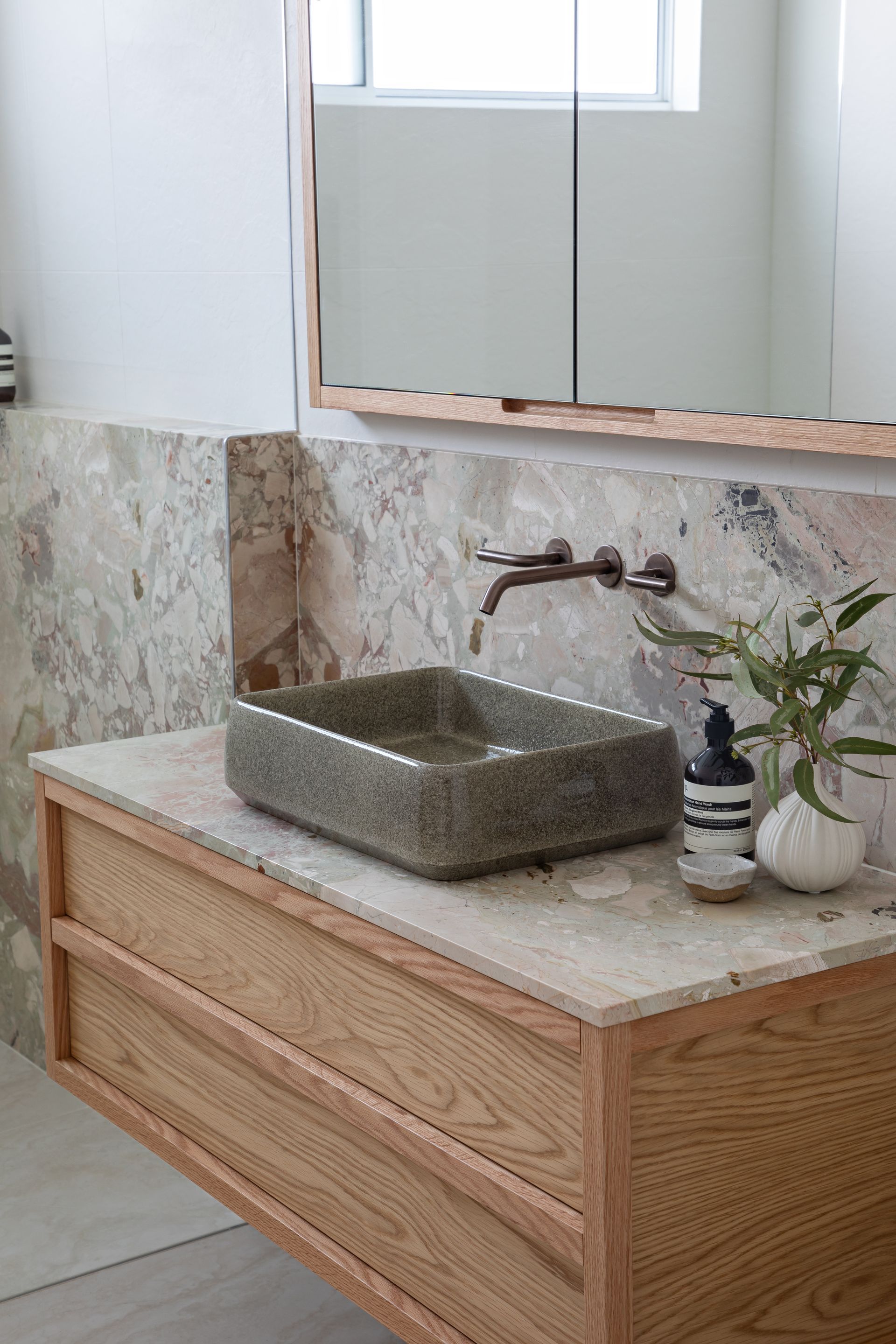 A Bathroom With a grey raised sink and timber cabinets — Paiano Custom Kitchens In Corrimal, NSW