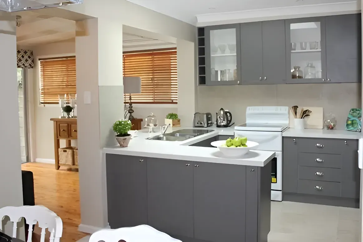 A Kitchen With Gray Cabinets and a White Stove Top Oven — Paiano Custom Kitchens In Corrimal, NSW