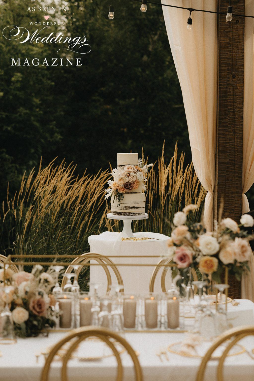 A table set for a wedding reception with a cake on top of it.