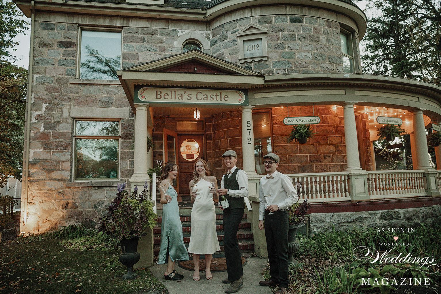 A group of people are standing in front of a large stone building.