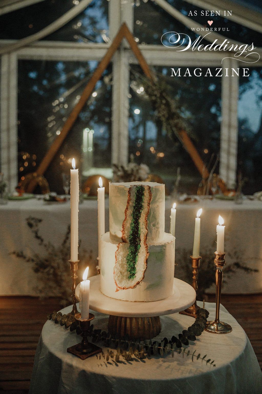 A wedding cake is sitting on a table with candles.