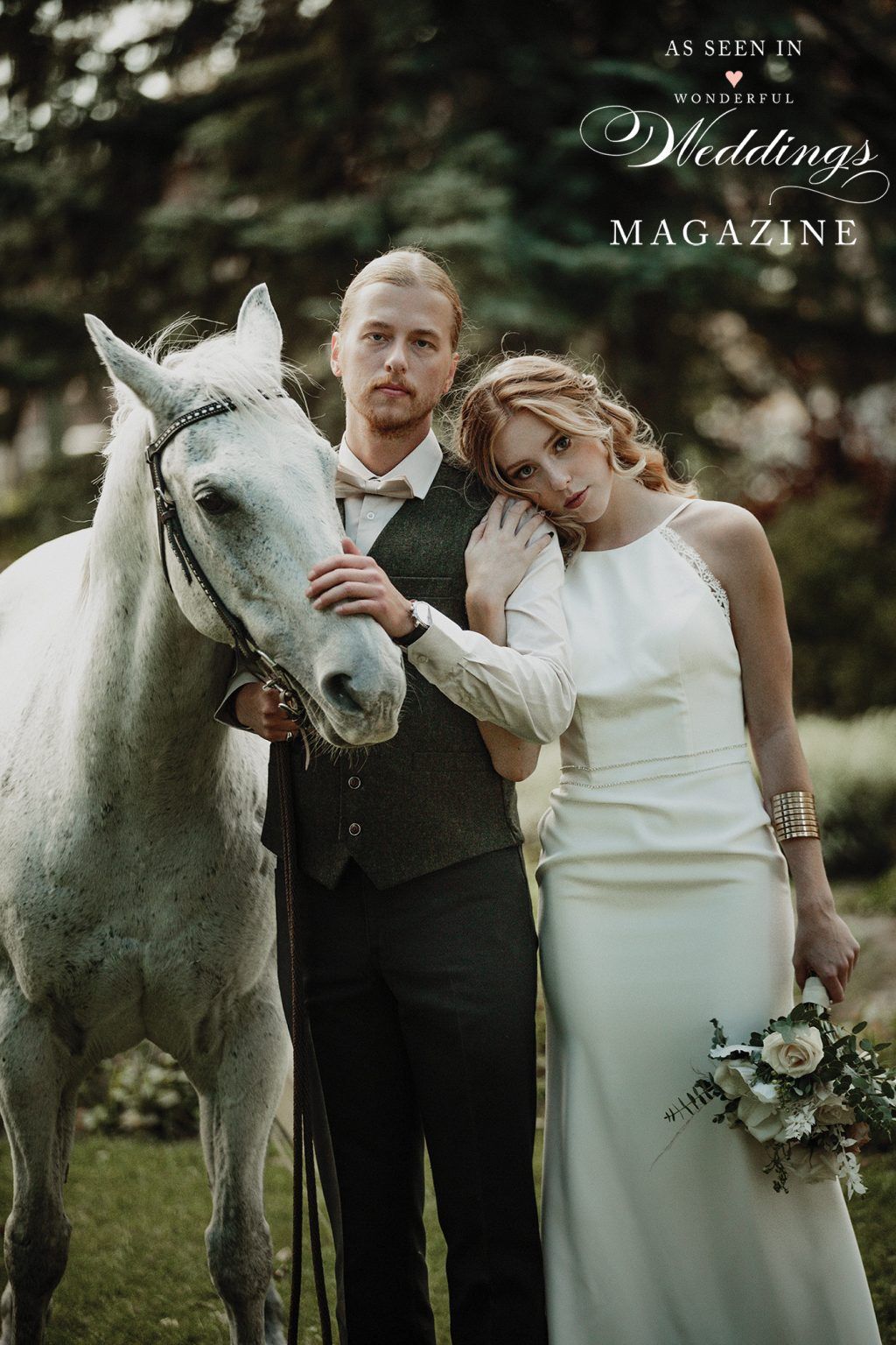 A bride and groom are posing for a picture with a white horse.