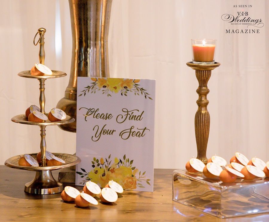 A table with a sign that says please find your seat