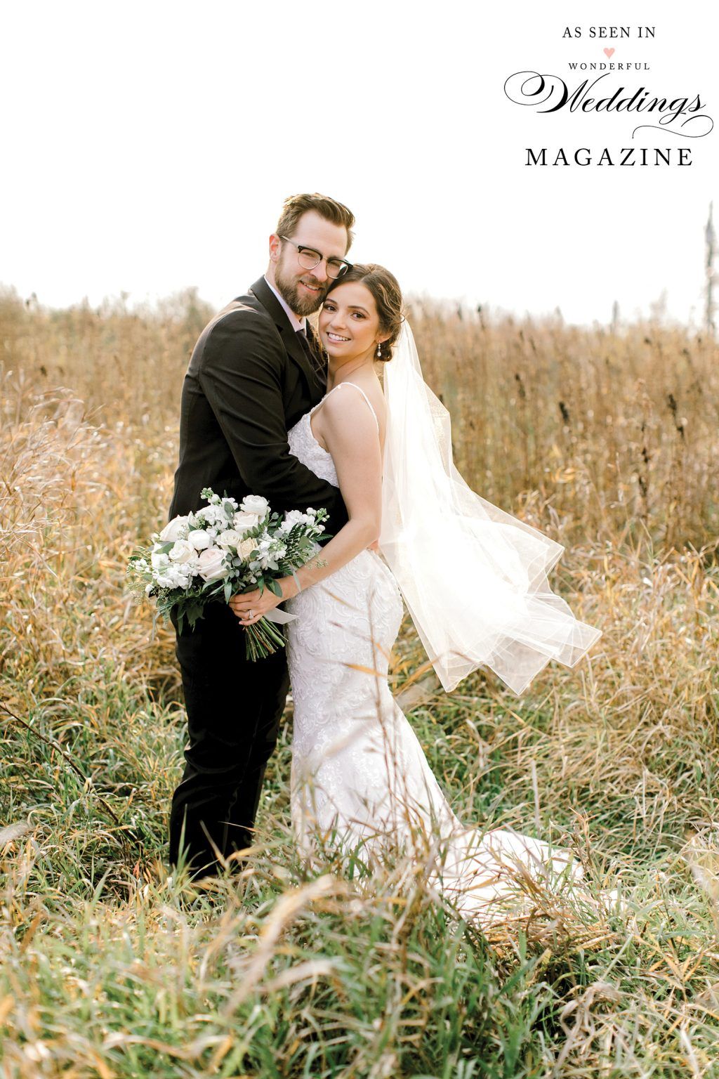 A bride and groom are posing for a picture in a field.