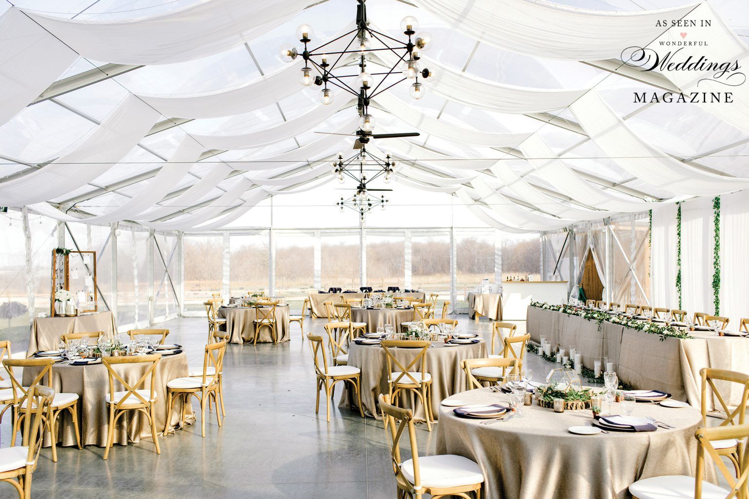A large room with tables and chairs set up for a wedding reception.