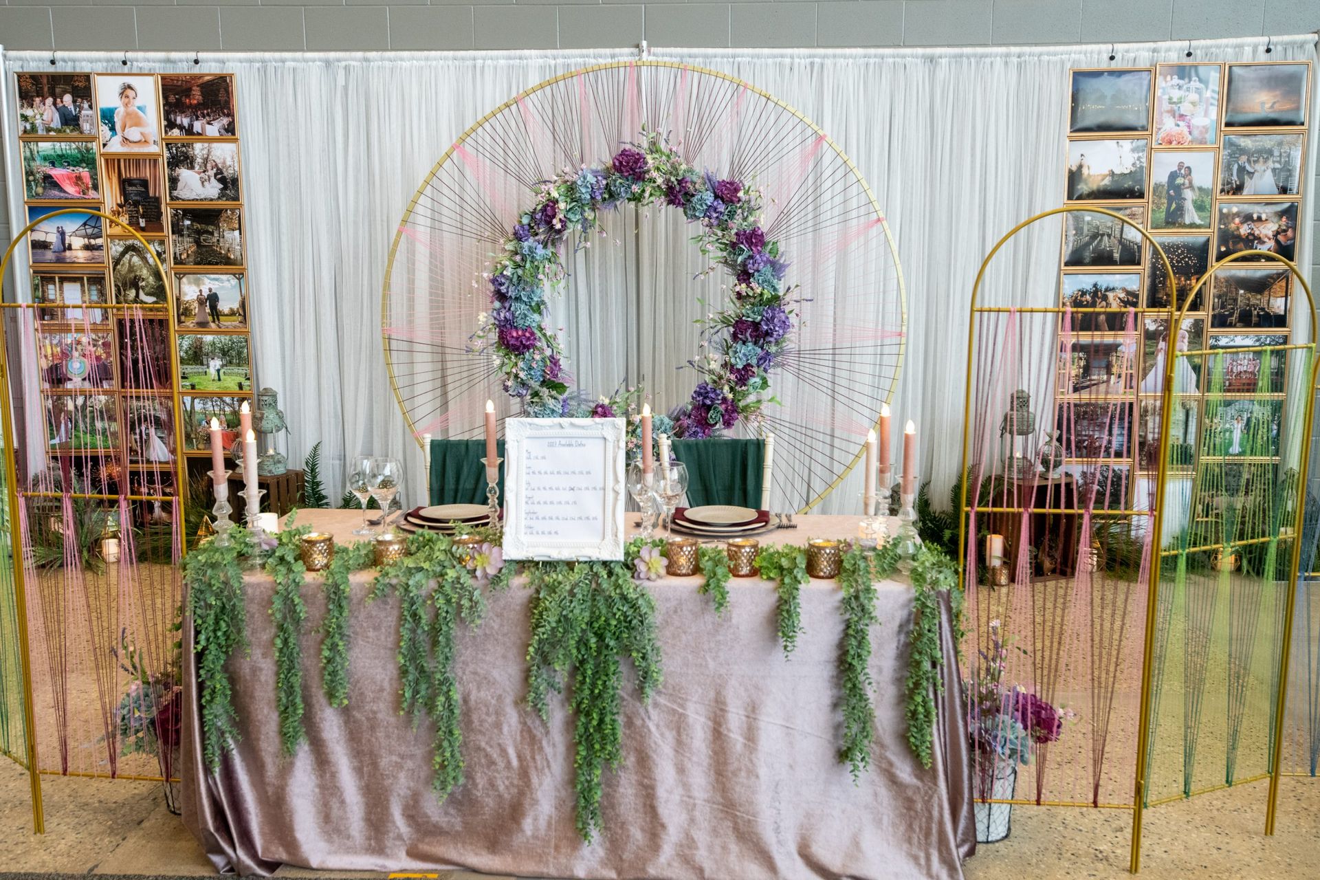 A long table with a wreath of flowers and candles on it.
