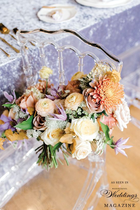 A clear chair with a bouquet of flowers on it.