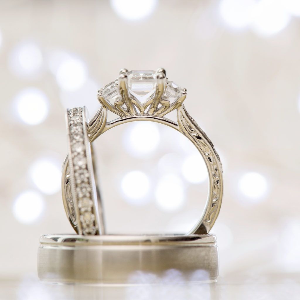 A close up of a wedding ring and engagement ring
