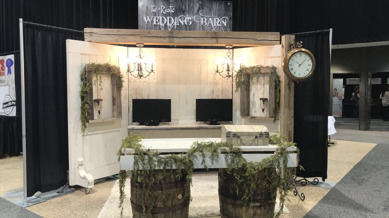 A booth with two barrels and a clock on it.