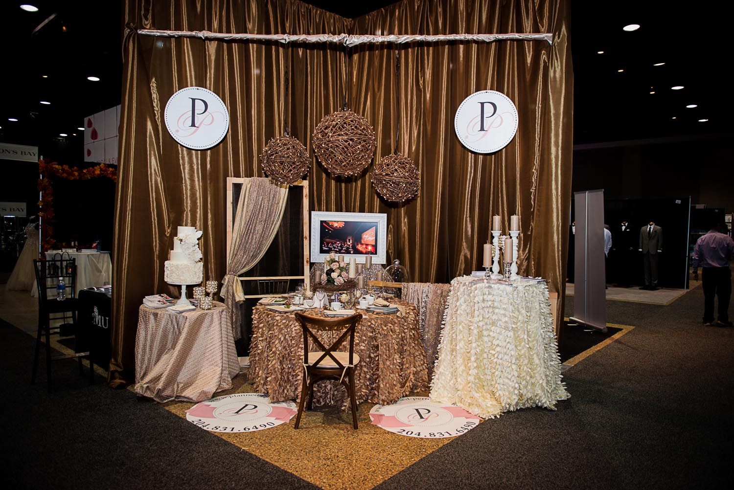 There is a table with a cake on it in the middle of the room.