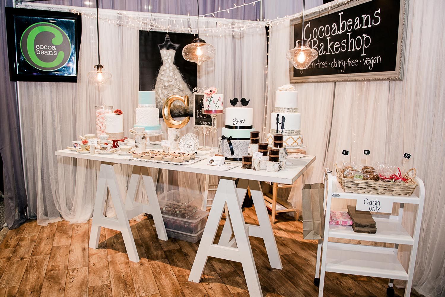 There is a table with a lot of cakes on it.