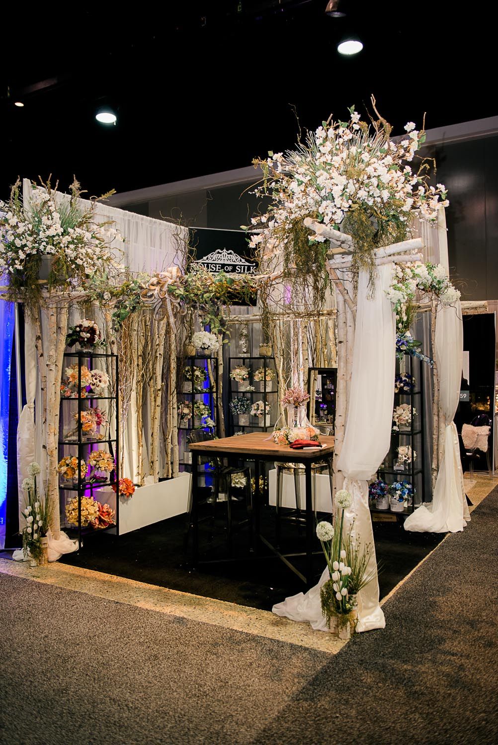 A room with a table and flowers in it