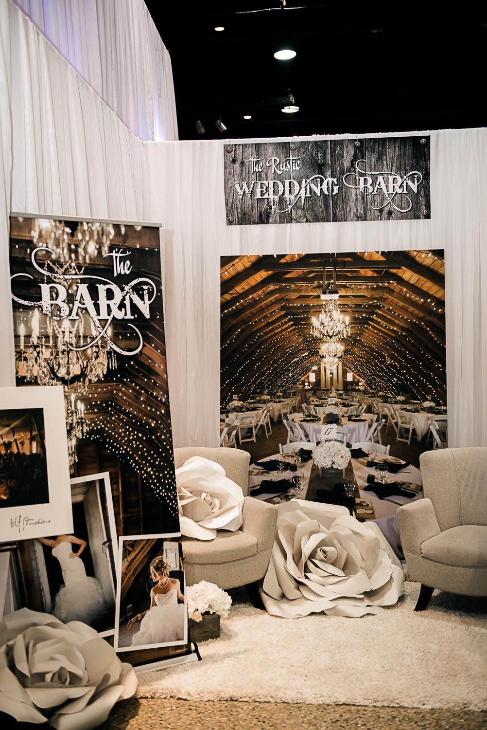 A room filled with furniture and a large picture of a barn.