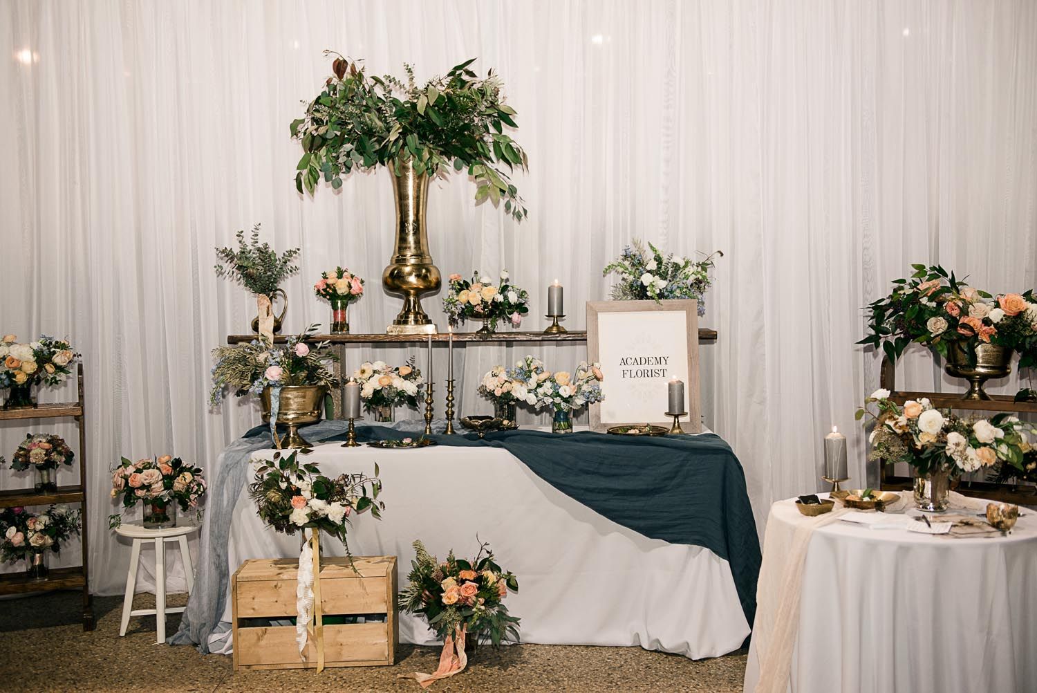 A table with flowers and candles on it in a room.