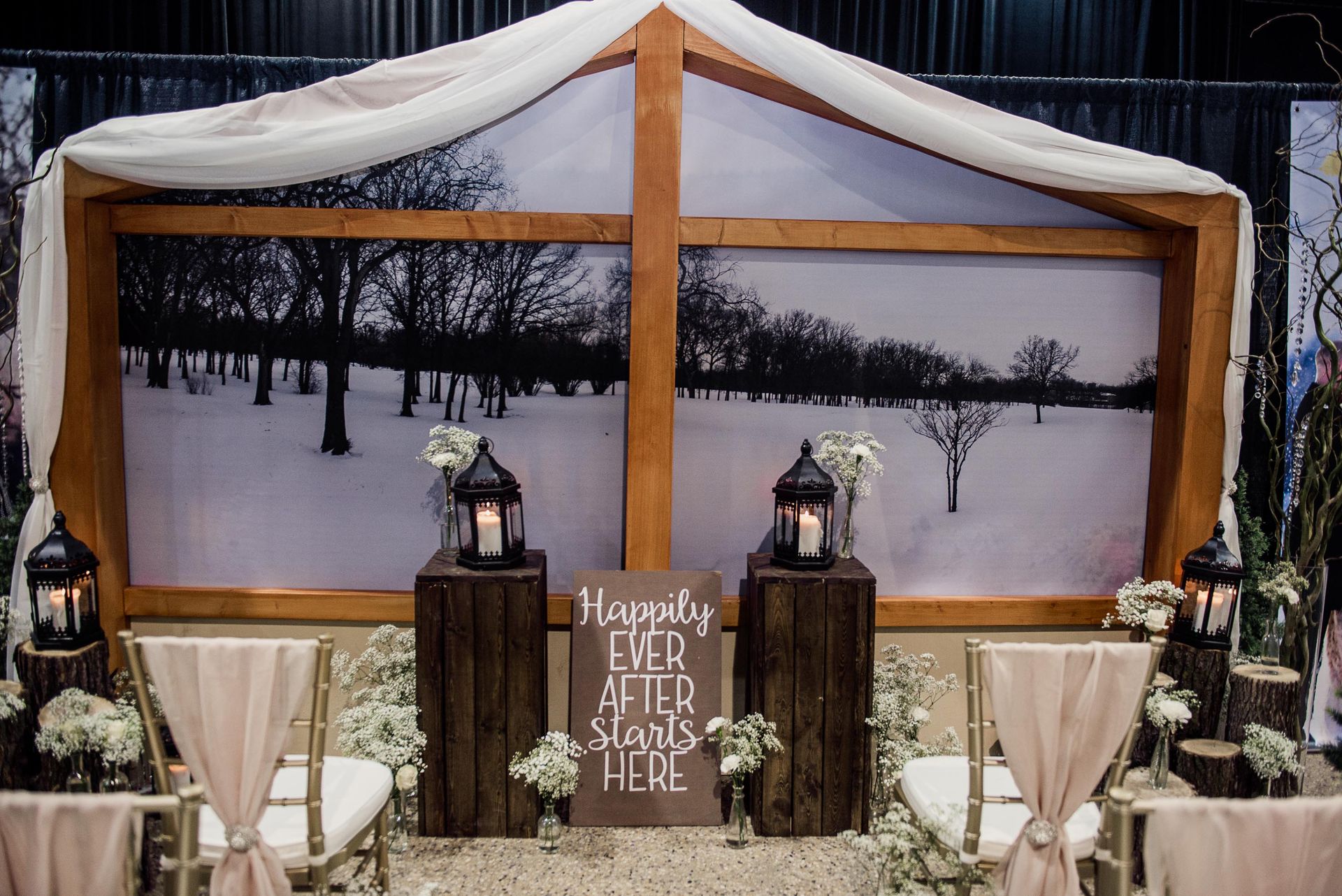 A wedding ceremony with a sign that says `` happily ever after starts here ''.