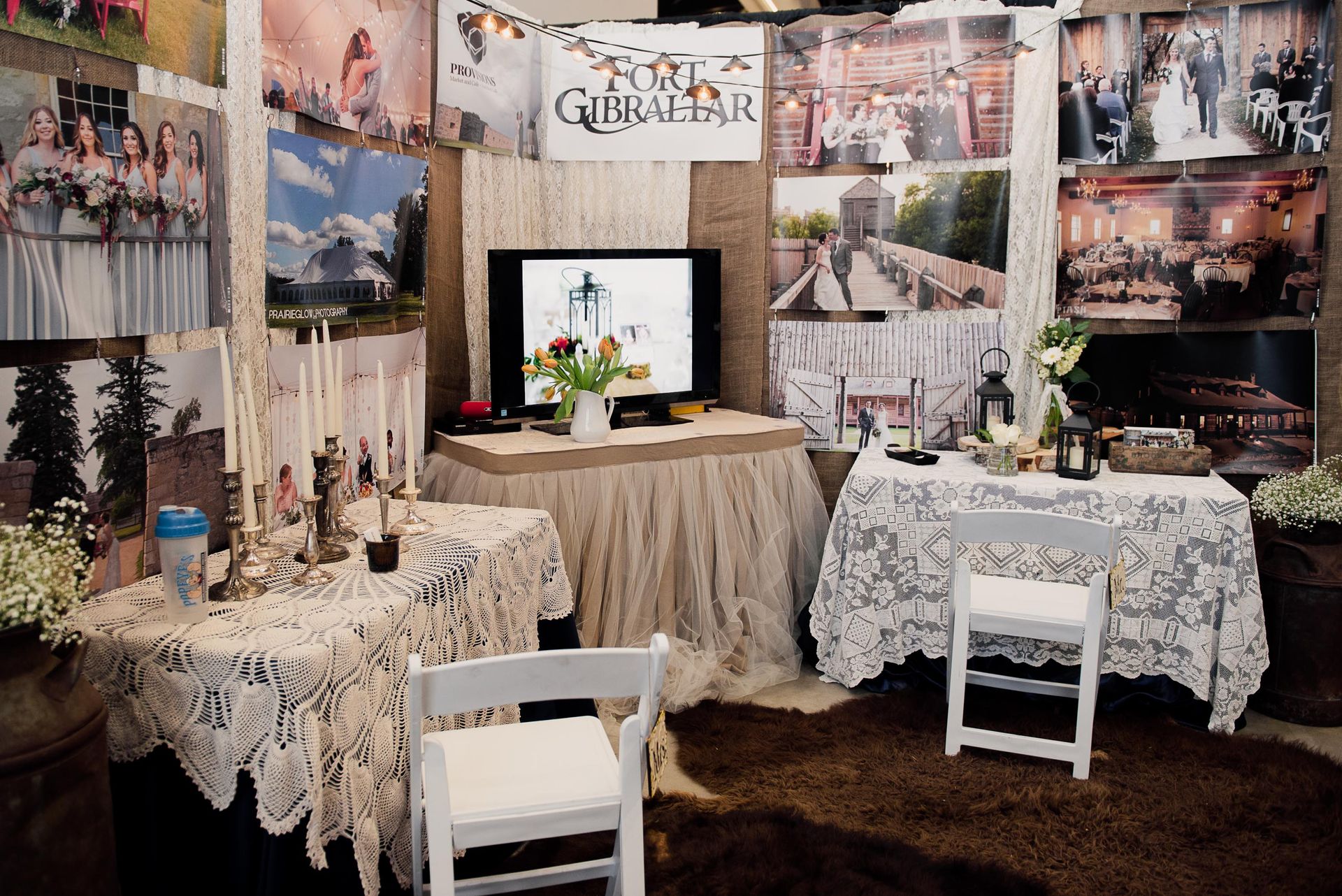 A room with a table , chairs , and a tv with a sign that says ' the ginger hair ' on it