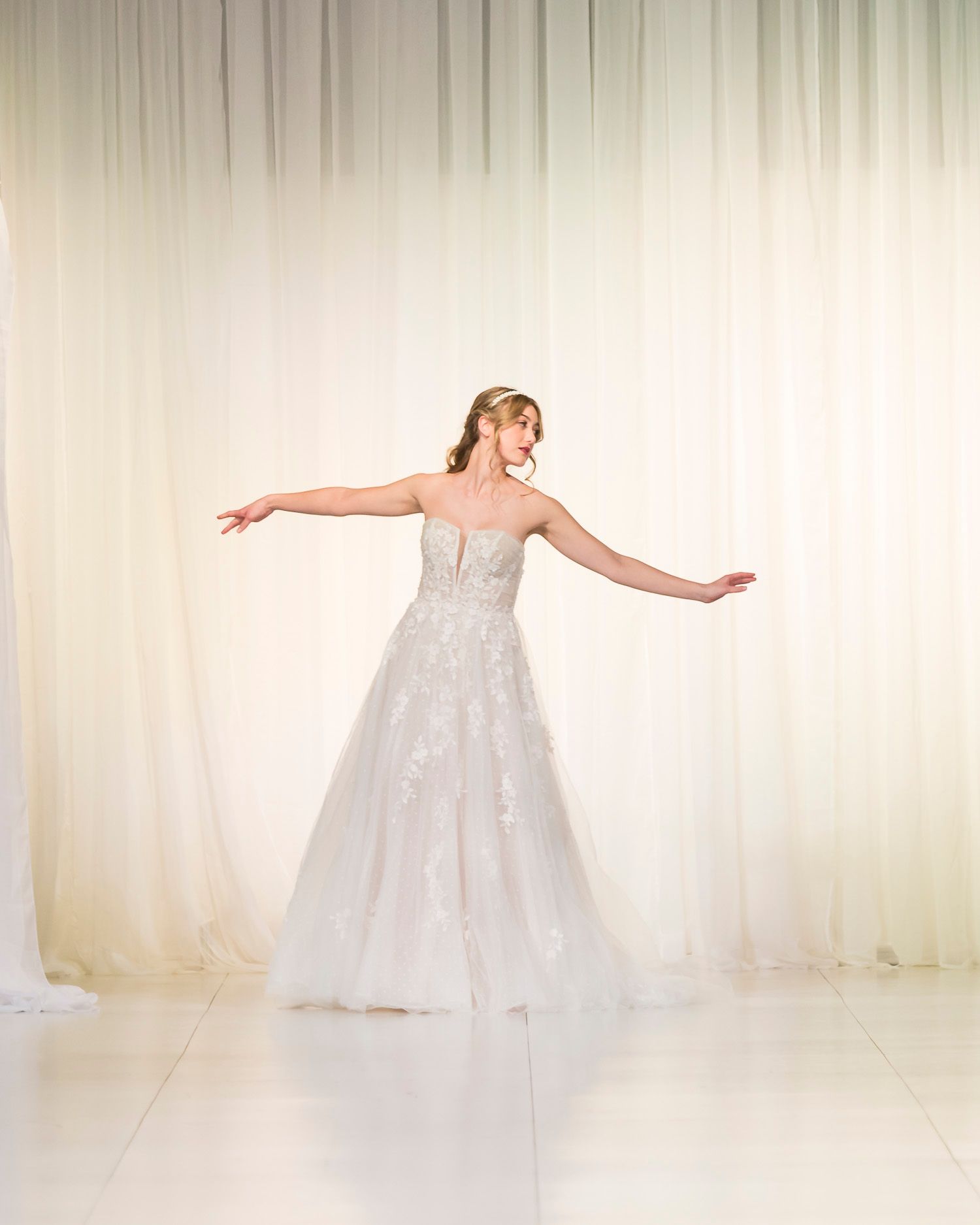A woman in a wedding dress is standing in a garden.