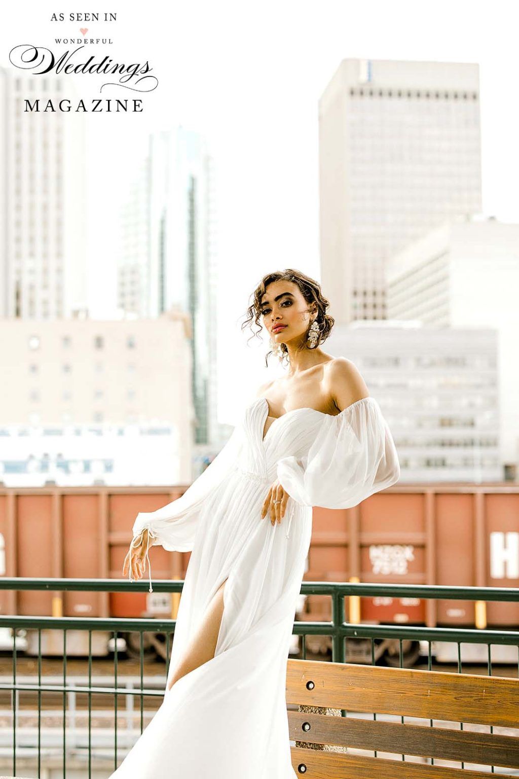 A woman in a white dress is standing next to a railing.