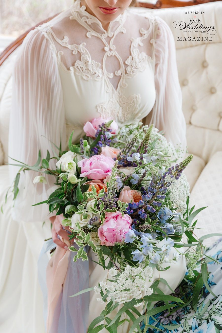 A woman in a wedding dress is holding a bouquet of flowers.